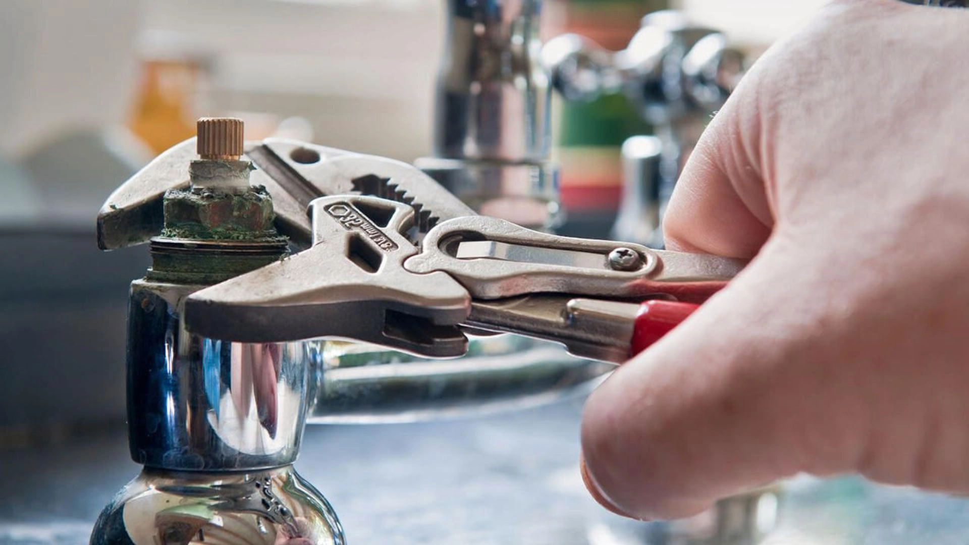 Handyman fixing tap